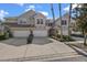 Attractive townhomes featuring stone accents, three-car garages, and landscaped yards at 14418 Mirabelle Vista Cir, Tampa, FL 33626