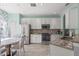 Bright kitchen with stainless steel appliances, white cabinets, and a charming breakfast nook at 14418 Mirabelle Vista Cir, Tampa, FL 33626