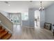 Bright open-concept living space with hardwood floors, flowing into the kitchen area at 14418 Mirabelle Vista Cir, Tampa, FL 33626
