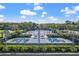 Aerial view of multiple tennis courts surrounded by lush greenery and palm trees at 14418 Mirabelle Vista Cir, Tampa, FL 33626