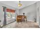Cozy dining area featuring a stylish bar, two chairs, decorative lighting, and a window at 1536 Norwick Dr, Lutz, FL 33559