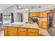 Kitchen island with granite countertop, stainless steel appliances and views of the pool at 1536 Norwick Dr, Lutz, FL 33559
