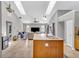 Open-concept kitchen with center island, skylights, stainless steel appliances, and access to living area at 1536 Norwick Dr, Lutz, FL 33559