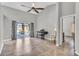 Bright living room with tile floors, piano, ceiling fan, and sliding glass doors to the pool area at 1536 Norwick Dr, Lutz, FL 33559