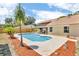 Backyard features a private pool and a covered outdoor dining area, perfect for entertaining at 1536 Norwick Dr, Lutz, FL 33559