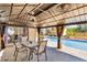 Poolside patio with covered seating area, ideal for entertaining or relaxing by the pool at 1536 Norwick Dr, Lutz, FL 33559