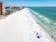 Stunning aerial view of a pristine white sandy beach with turquoise ocean water and clear blue skies at 17960 Gulf Blvd # 111, Redington Shores, FL 33708