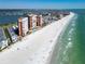 Coastal aerial shot showcasing luxury condos, a sparkling beachfront, and the serene turquoise waters along the shoreline at 17960 Gulf Blvd # 111, Redington Shores, FL 33708