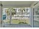 Balcony showcasing an outdoor seating area with white railings, tile flooring, and a view of the neighborhood at 17960 Gulf Blvd # 111, Redington Shores, FL 33708