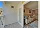 Balcony view into the living room with a leather sofa, pillows, and sliding door access at 17960 Gulf Blvd # 111, Redington Shores, FL 33708