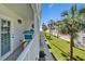 View from the balcony showcasing the property's manicured lawns and palm tree-lined walkway at 17960 Gulf Blvd # 111, Redington Shores, FL 33708
