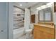 Clean and stylish bathroom with a bathtub and shower combination and neutral tile accents at 17960 Gulf Blvd # 111, Redington Shores, FL 33708
