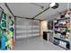 Clean garage with epoxy flooring, shelving, and storage space; door to interior at 17960 Gulf Blvd # 111, Redington Shores, FL 33708
