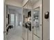 Hallway featuring mirrored closet doors, a ceiling fan, and multiple rooms at 17960 Gulf Blvd # 111, Redington Shores, FL 33708