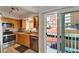 Well-equipped kitchen featuring granite countertops and access to a balcony with city views at 17960 Gulf Blvd # 111, Redington Shores, FL 33708