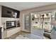 Cozy living room featuring a fireplace and sliding glass doors to the balcony with outdoor views at 17960 Gulf Blvd # 111, Redington Shores, FL 33708