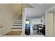 View of the living room, dining room, and stairway with wood-look flooring at 17960 Gulf Blvd # 111, Redington Shores, FL 33708