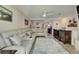 Open living room with a leather sofa, entertainment center, and view into the entryway at 17960 Gulf Blvd # 111, Redington Shores, FL 33708