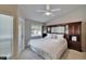 Main bedroom with plush carpet, ceiling fan, balcony access, and an ensuite bathroom, creating a private retreat at 17960 Gulf Blvd # 111, Redington Shores, FL 33708