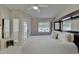 Spacious bedroom featuring neutral colors, a ceiling fan, and balcony access allowing ample natural light at 17960 Gulf Blvd # 111, Redington Shores, FL 33708