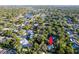Aerial view showing the property with mature trees, landscaping, and location near lake at 1880 Belleair Rd, Clearwater, FL 33764