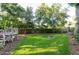 Lush backyard with green lawn, privacy fence, and a fire pit, perfect for outdoor enjoyment at 1880 Belleair Rd, Clearwater, FL 33764