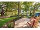 Inviting backyard deck features rocking chairs and a lush landscaped yard with mature trees at 1880 Belleair Rd, Clearwater, FL 33764