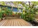 Relaxing backyard deck features a charming garden pond and decorative statue for serene outdoor living at 1880 Belleair Rd, Clearwater, FL 33764