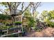 The backyard has a gardening area with a tree house and lots of plants in pots at 1880 Belleair Rd, Clearwater, FL 33764