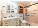 Beautiful bathroom featuring a modern vanity, a glass-enclosed shower, and neutral color palette at 1880 Belleair Rd, Clearwater, FL 33764