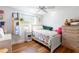 Bright bedroom with wood floors and a cozy bed, complemented by a window and a ceiling fan at 1880 Belleair Rd, Clearwater, FL 33764