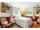 Cozy bedroom featuring a floral-themed bedspread, charming decor, and a comfortable reading nook at 1880 Belleair Rd, Clearwater, FL 33764