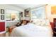Bright bedroom with a mirrored closet reflecting the room and a window providing natural light at 1880 Belleair Rd, Clearwater, FL 33764