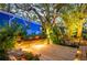 Illuminated outdoor deck with lush tropical plants, and subtle ambient lighting at 1880 Belleair Rd, Clearwater, FL 33764