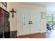 Welcoming entryway features a striking double front door with decorative glass panels and wood laminate flooring at 1880 Belleair Rd, Clearwater, FL 33764