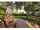 Inviting front deck with rocking chairs, lush landscaping, and serene views, perfect for relaxation at 1880 Belleair Rd, Clearwater, FL 33764