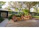 Inviting front deck with rocking chairs, lush landscaping, and serene views, perfect for relaxation at 1880 Belleair Rd, Clearwater, FL 33764
