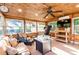 Comfortable sunroom with wood details, multiple windows, and plenty of seating at 1880 Belleair Rd, Clearwater, FL 33764