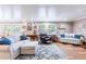 Cozy living room features hardwood floors, comfortable seating, and natural light through large windows at 1880 Belleair Rd, Clearwater, FL 33764