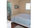 Comfortable bedroom featuring wood floors and serene bathroom access at 1942 Settlement Rd # 25, Venice, FL 34285