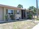 Charming condo showcasing tidy front lawn and screened in entrance for relaxed outdoor living at 1942 Settlement Rd # 25, Venice, FL 34285