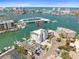 Aerial view of waterfront condo featuring a pool, boat docks, and stunning water views at 211 Dolphin Pt # 403, Clearwater Beach, FL 33767