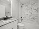Modern bathroom features marble tile, white vanity, and shower-tub combination at 211 Dolphin Pt # 403, Clearwater Beach, FL 33767