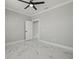Spacious bedroom featuring marble floors, neutral walls, crown molding, and an open doorway at 211 Dolphin Pt # 403, Clearwater Beach, FL 33767