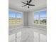 Bright bedroom with marble floors featuring two large windows showcasing the scenic water views at 211 Dolphin Pt # 403, Clearwater Beach, FL 33767