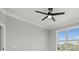 Bright bedroom featuring a modern ceiling fan and a large window with a water view at 211 Dolphin Pt # 403, Clearwater Beach, FL 33767