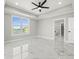 Bright bedroom featuring tray ceiling, marble floors, and waterfront view at 211 Dolphin Pt # 403, Clearwater Beach, FL 33767