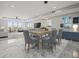 Open-concept dining room with elegant furnishings, marble floors, and ample natural light at 211 Dolphin Pt # 403, Clearwater Beach, FL 33767