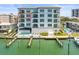 A beautiful view of the building exterior, including the pool, dock, and waterway at 211 Dolphin Pt # 403, Clearwater Beach, FL 33767