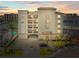 Stunning exterior shot of a white building with a parking garage and waterway views at 211 Dolphin Pt # 403, Clearwater Beach, FL 33767